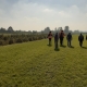 People walking across field