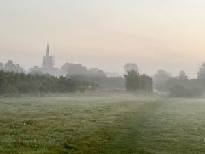 St Nicholas Church across open fields in the mist
