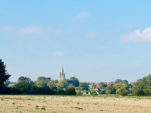 St Nicholas Church across open field in the afternoon